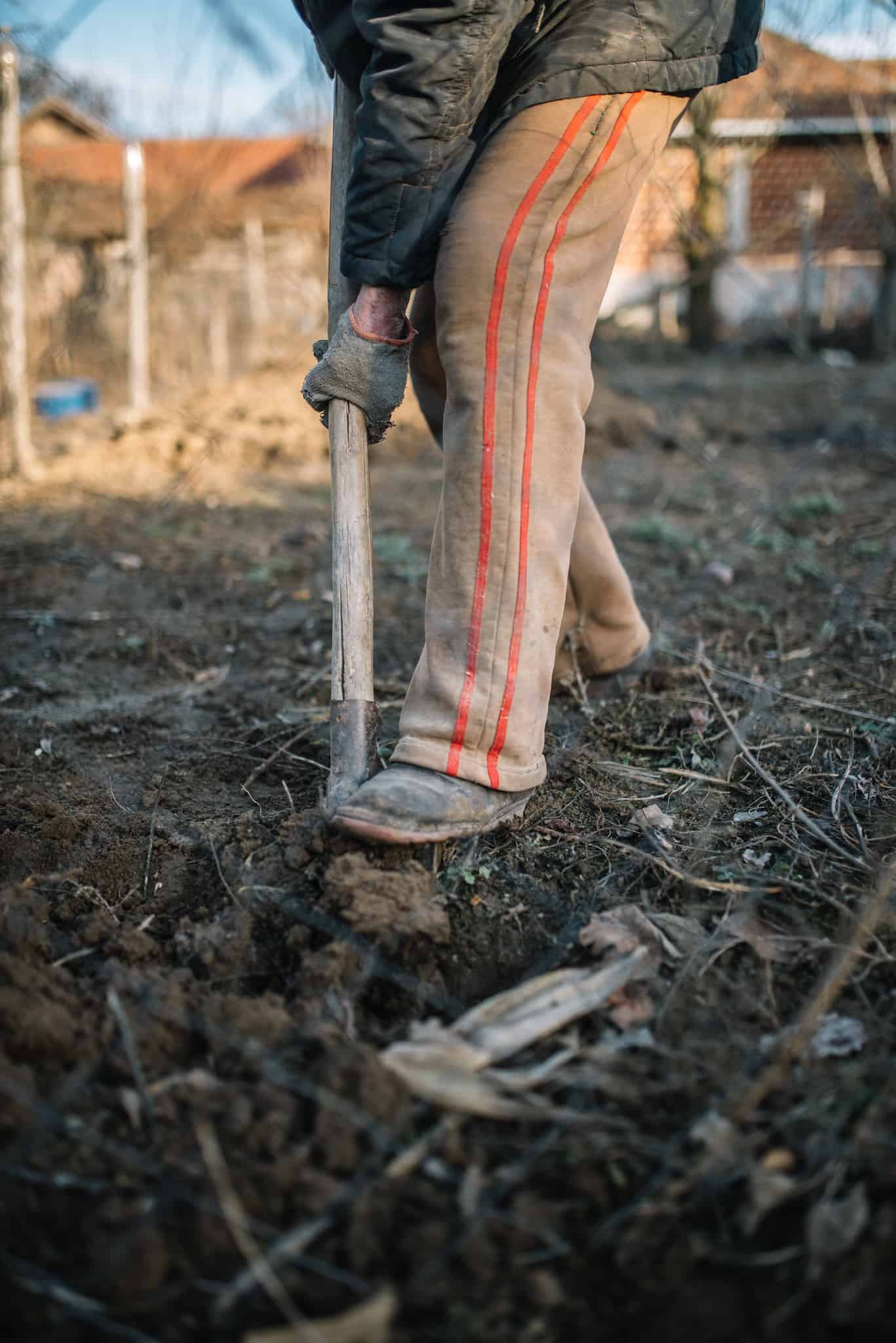 "A man digs the ground with a shovel" by Nenad Stojkovic is licensed under CC BY 2.0