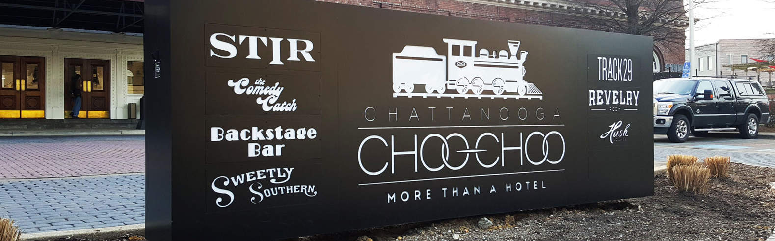 Sign in front of the Chattanooga Choo Choo featuring businesses on location