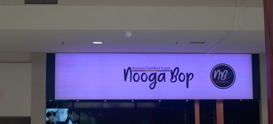 Nooga Bop's LED sign lit up purple in Hamilton Place Mall