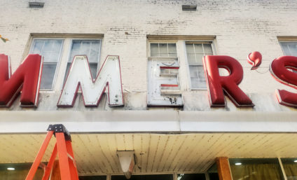 Channel letters sign faces exposed on building