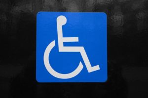 International Symbol of Access in blue square on black background