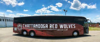 Chattanooga Red Wolves bus newly wrapped in parking lot on bright summer day