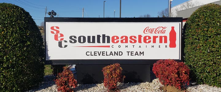 Coca Cola Southeastern Team Container monument sign between 2 bushes