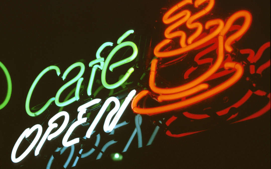 Cafe Open neon sign with coffee cup and words in neon