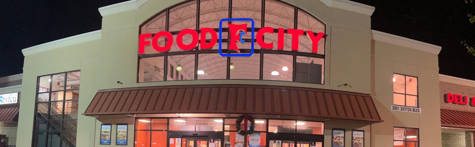 Channel letters on Food city grocery store facade lit up at night